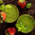 Two green smoothies and strawberries